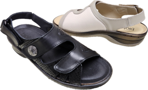 Women's sandal, comes in a black and a beige, two straps at the front and one around the heel, stretchable material around the bunion