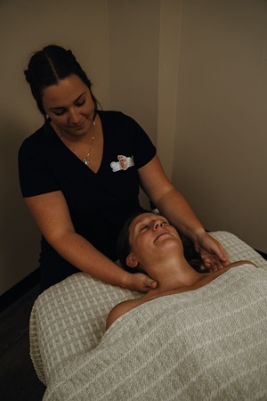 Massage therapy session - massaging neck and shoulders