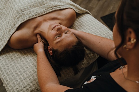 Massaging the shoulders during a massage therapy session