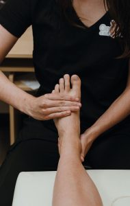 Practitioner assessing range of motion in the foot